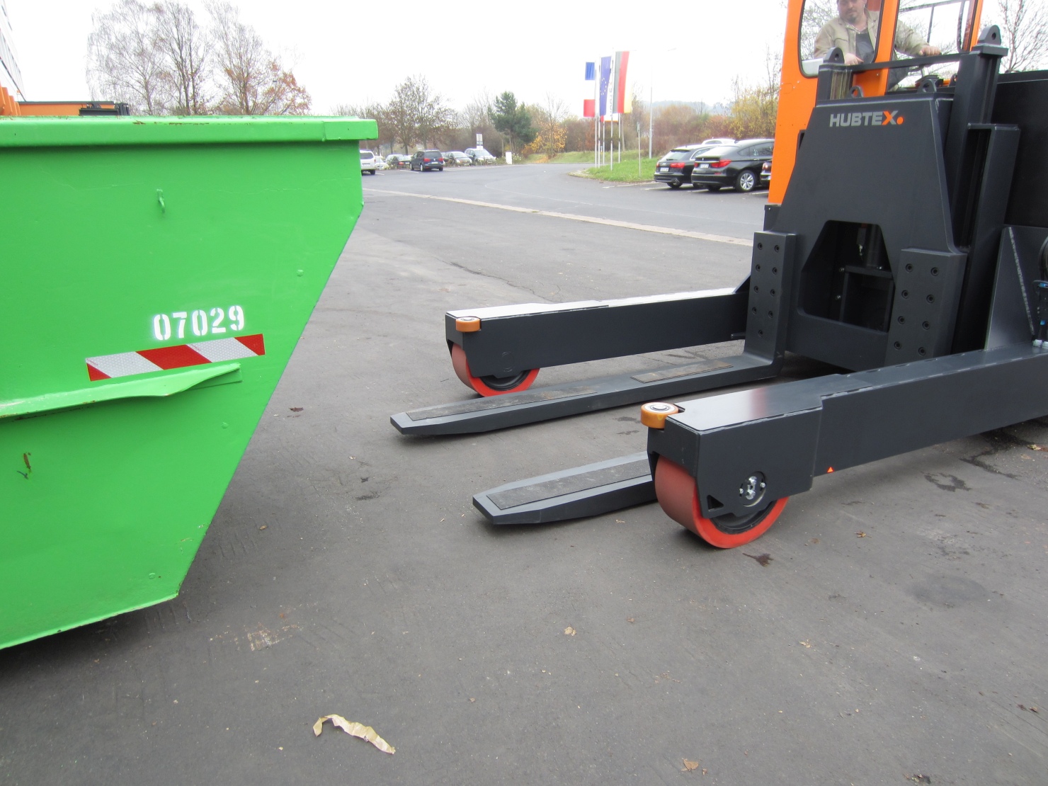 A skip transporter lifts a skip.