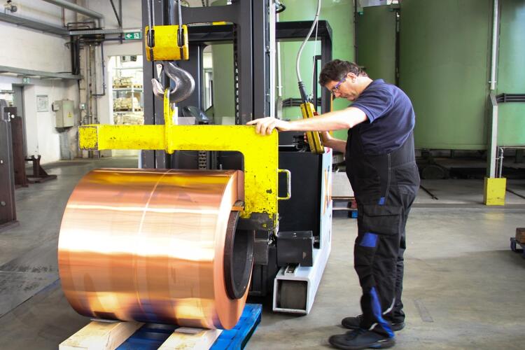 Hubtex reach truck is transporting a coil