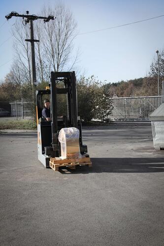 The HUBTEX reach truck handles a copper coil in outdoor use.