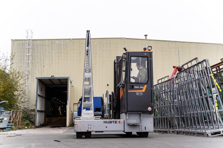 HUBTEX vehicle transports glass racks across the yard