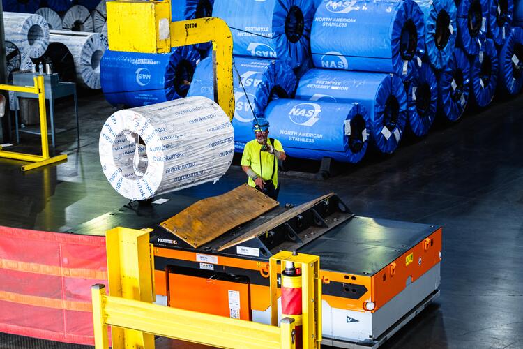 HUBTEX SFX 40 heavy-duty vehicle being loaded with a coil