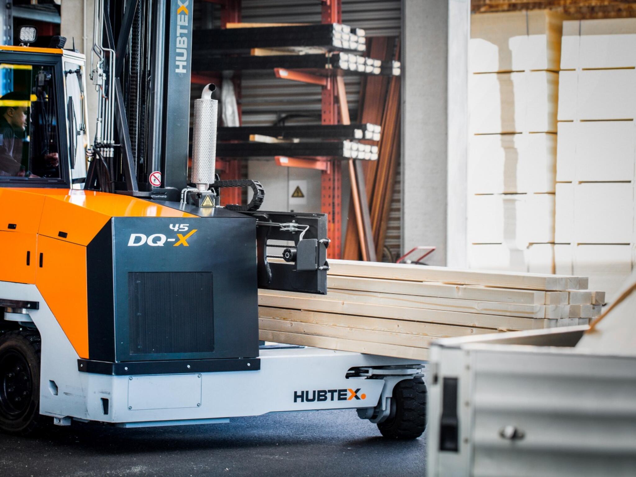 Hubtex Sideloader forklift is handling wood
