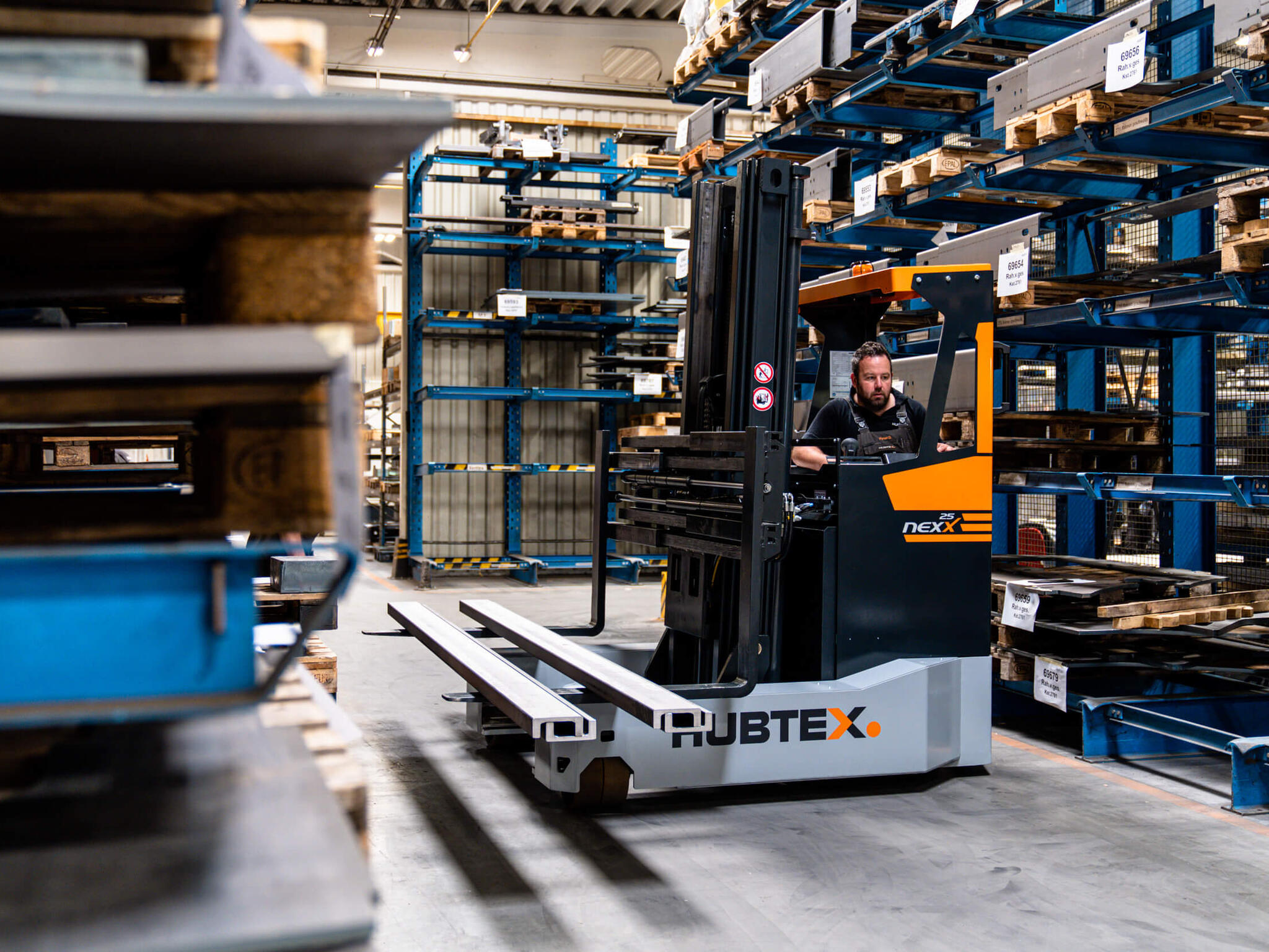 Reach truck transports metal parts