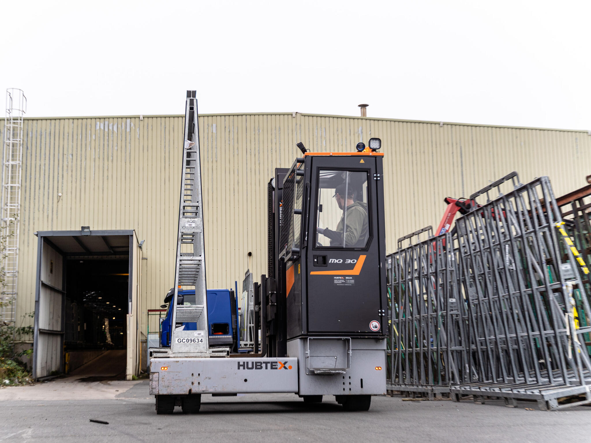 HUBTEX vehicle transports glass racks across the yard