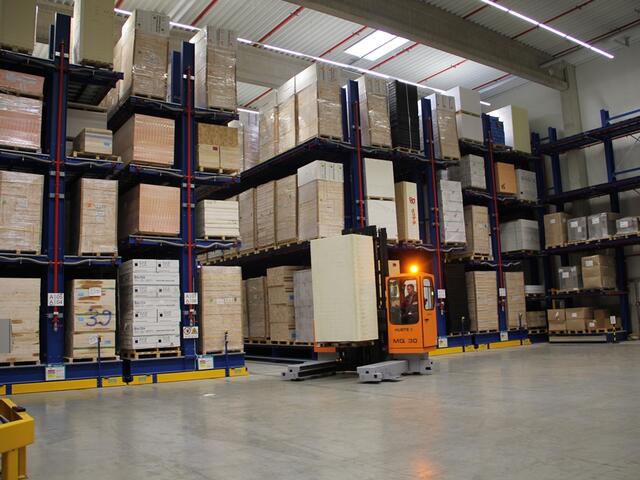 Electric multidirectional sideloader in use in the plastics industry