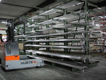 HUBTEX BasiX Mehrwege-Stapler bei der Lastaufnahme von Profilen