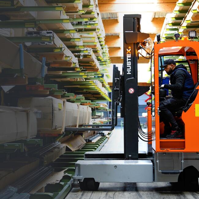 Narrow aisles sideloader handling material in narrow aisles