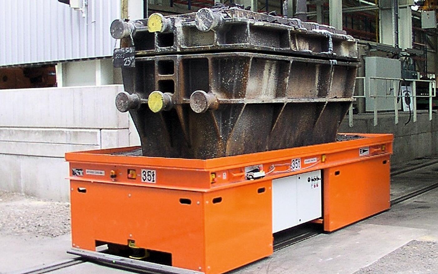 The rail-mounted truck with a tool on the support surface. 
