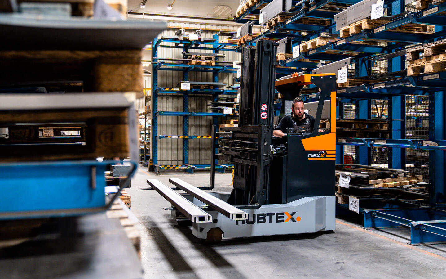 Reach truck transports metal parts