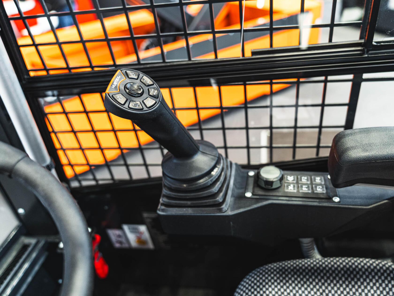 HUBTEX Bedienung mit Joystick mit ergonomischer Daumenablage, Fahrtrichtungswippe und beleuchteten Tasten für präzise Steuerung im Schmalganglager
